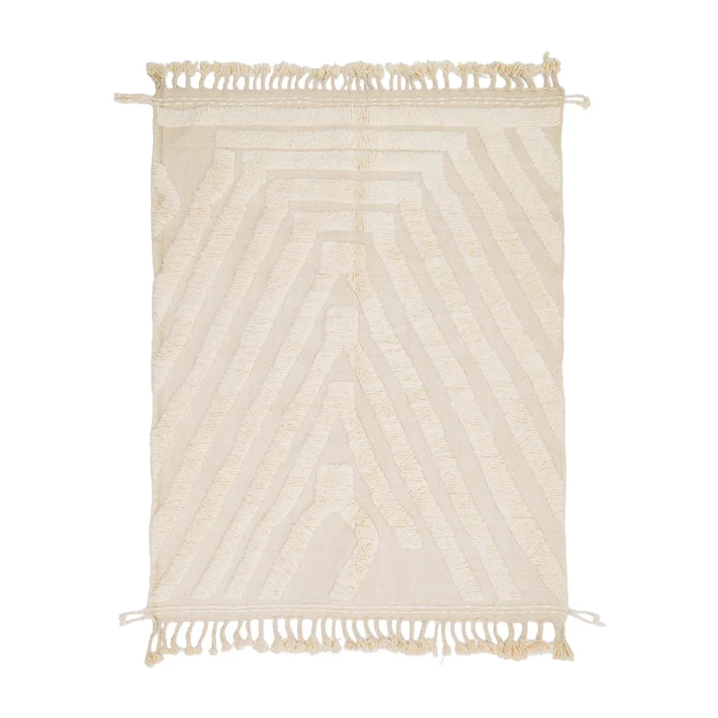 This luxury rug is a beige woven masterpiece, featuring intricate geometric patterns and fringe along the shorter edges, exuding elegance through its hand-knotted design.