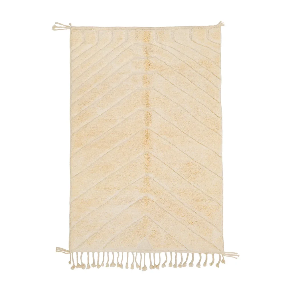 This rectangular beige rug features a captivating geometric pattern and is enhanced by tasseled edges on the shorter sides, creating an elegant focal point for any room.