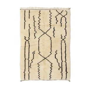 This beige, hand-knotted rug with a shaggy texture boasts abstract black zigzag and linear patterns, adding a touch of handmade home decor to any space.