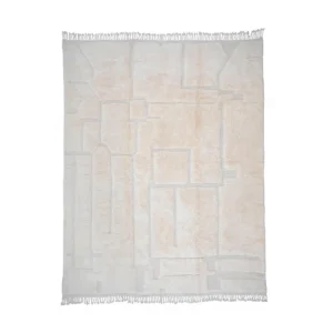A luxurious beige area rug, hand-knotted with an abstract geometric pattern and fringed edges, adds an elegant touch to any space.