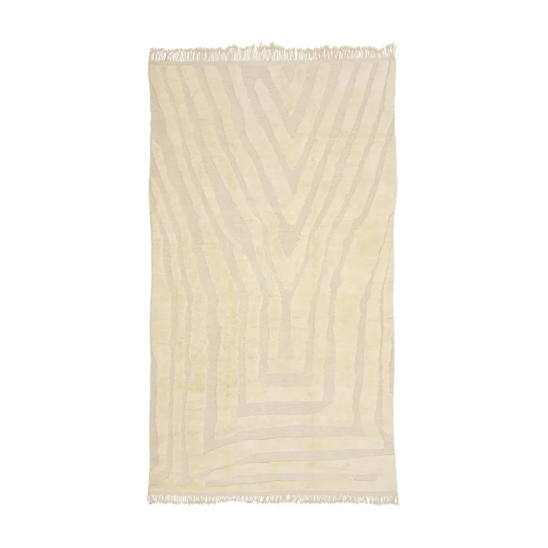 Authentic Moroccan rug in a cream color, featuring a subtle geometric pattern and fringed edges. This artisanal piece adds elegance to any room and provides the perfect blend of style and craftsmanship.