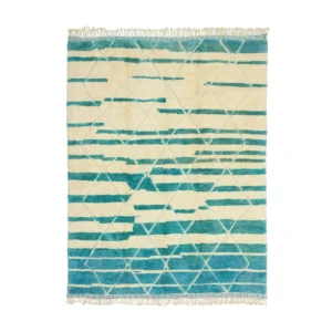 This luxury rug is hand-knotted with a geometric pattern in shades of teal and cream, featuring triangles and horizontal lines. Fringes adorn the shorter edges for an elegant touch.