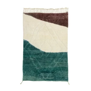 Experience the elegance of a handmade home decor piece with this rectangular area rug. Boasting an abstract design in cream, maroon, and teal green sections, it features fringed edges on one side. Perfect for adding a touch of sophistication to any room.