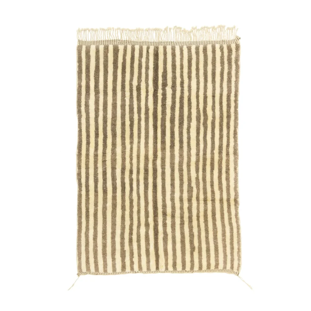 This hand-knotted rectangular rug features vertical brown and white stripes with fringe on one end, showcasing authentic Moroccan craftsmanship.