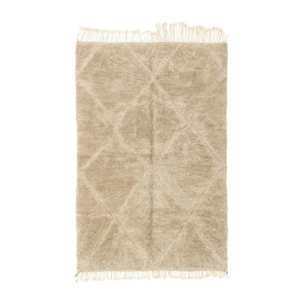 An authentic Moroccan rug with subtle geometric patterns and fringed edges on both ends, beautifully laid out flat against a white background.
