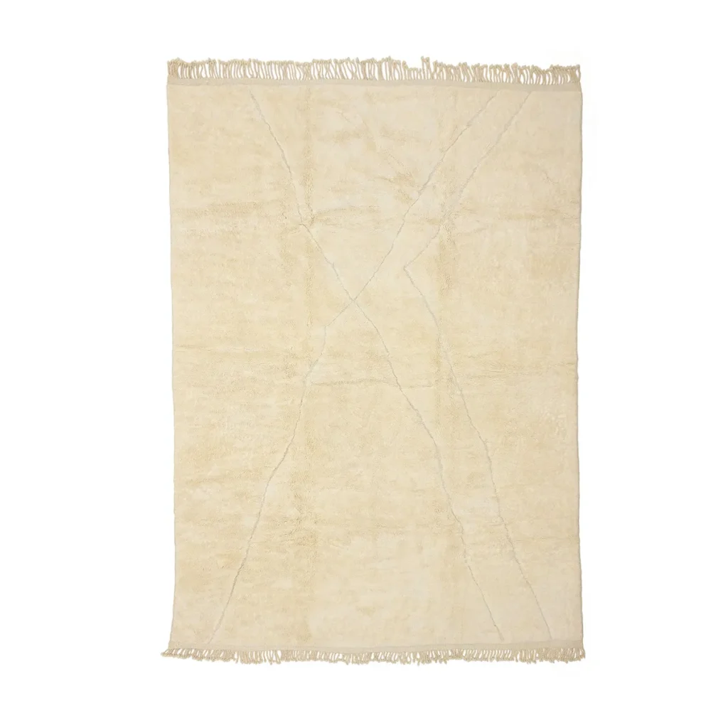 This luxurious, hand-knotted beige rug features a subtle crisscross pattern and fringed edges, beautifully showcased against a plain background.