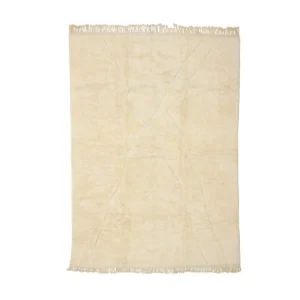 This luxurious, hand-knotted beige rug features a subtle crisscross pattern and fringed edges, beautifully showcased against a plain background.