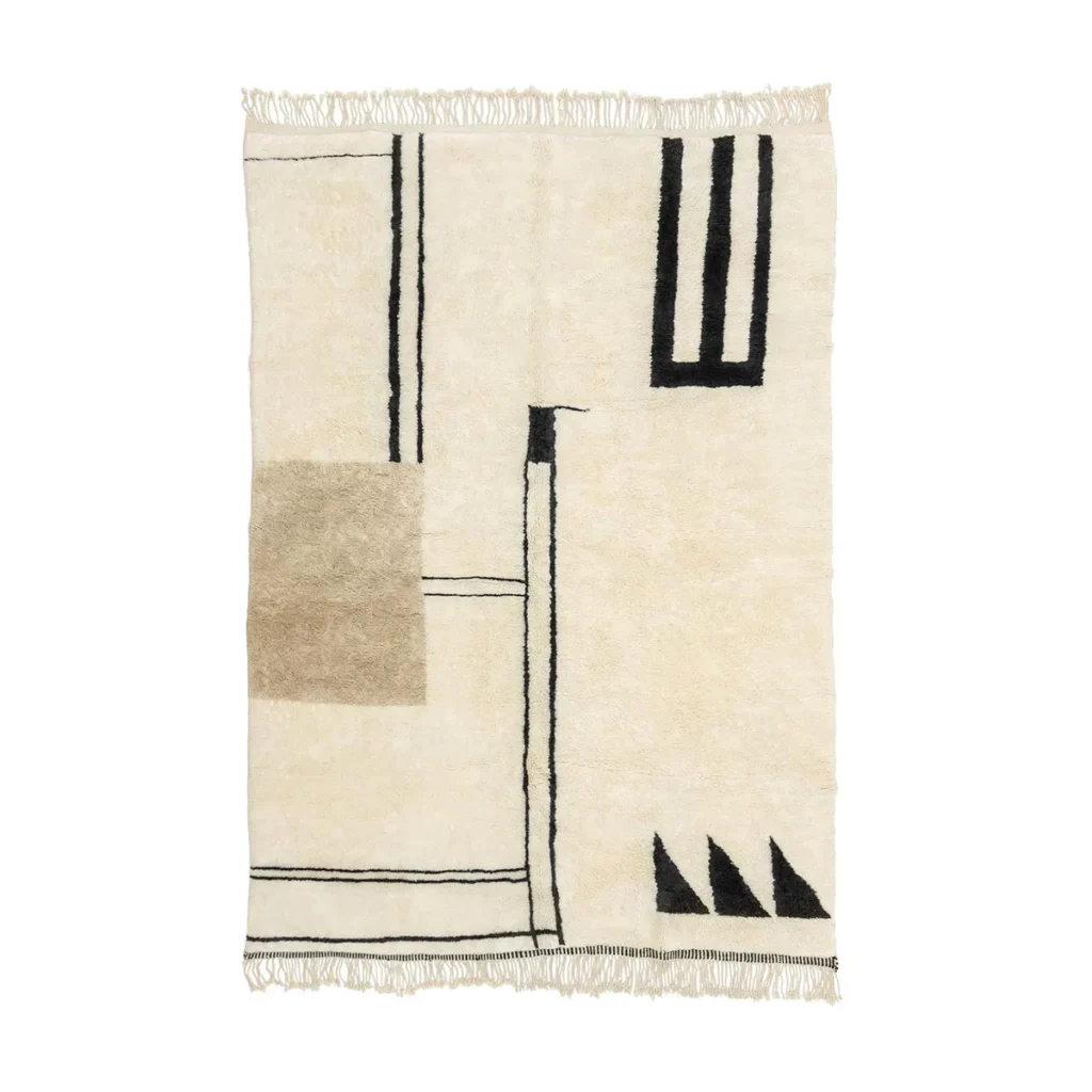 This hand-knotted rectangular rug features abstract geometric patterns in black and beige on a cream background. The design showcases lines, rectangles, and triangular shapes, complemented by fringe on the short ends, reflecting the artisanal craftsmanship of Authentic Moroccan Rugs.