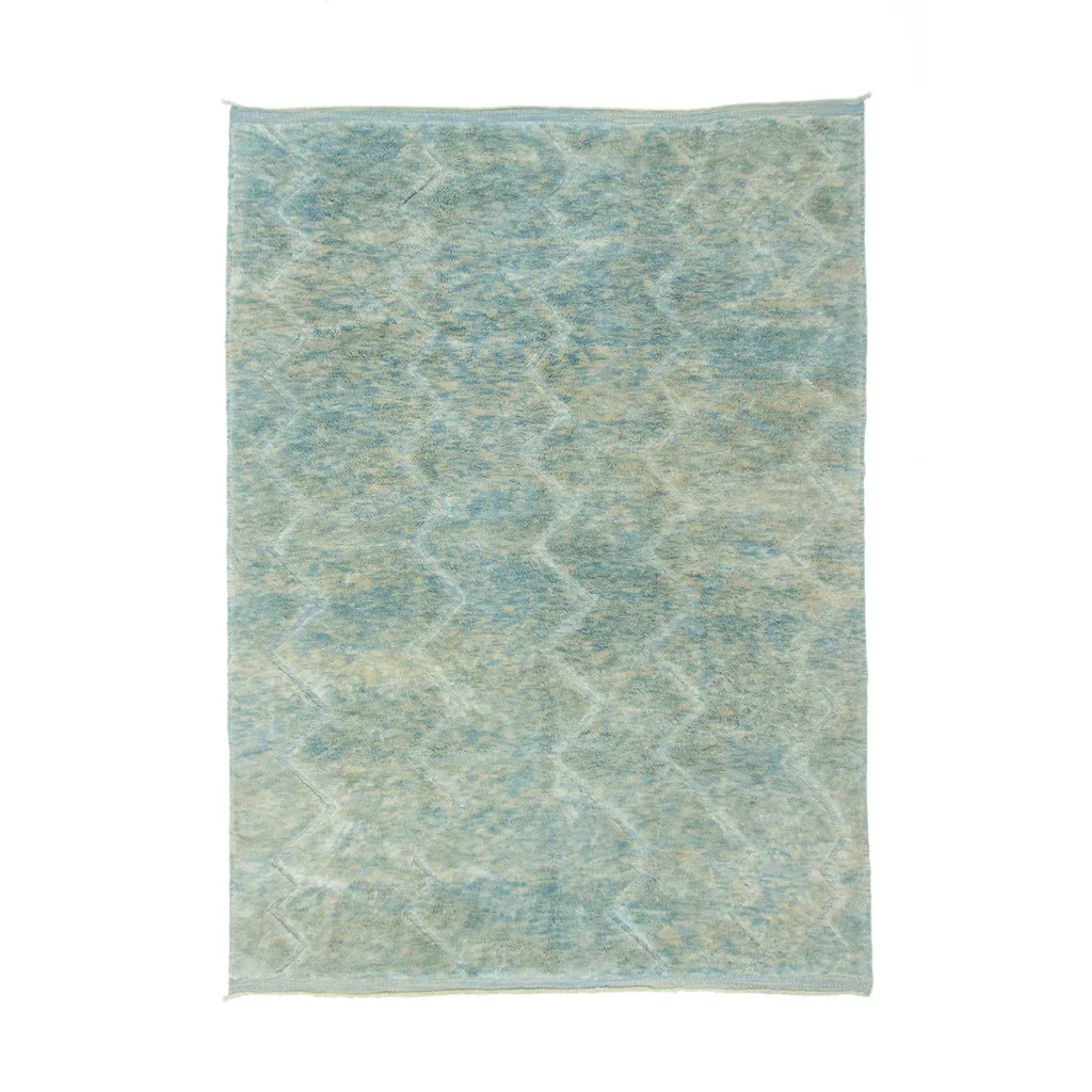 Experience the elegance of a hand-knotted, rectangular area rug featuring a textured surface with a subtle blue and green zigzag pattern. This artisanal piece adds a touch of sophistication to any room with its unique design.
