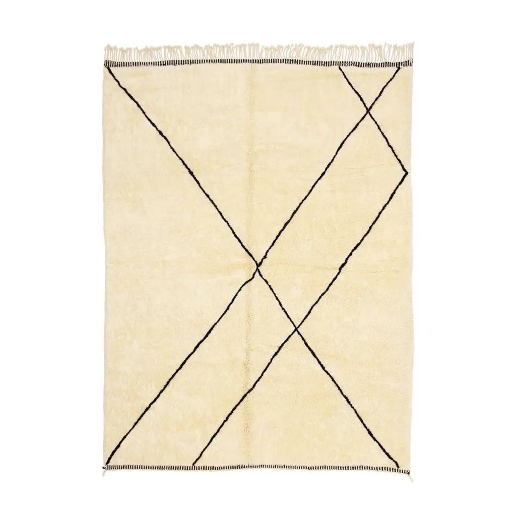 This hand-knotted beige rug showcases black geometric lines forming diamond shapes, complemented by fringed edges. A true embodiment of luxury, it adds an elegant touch to any room.