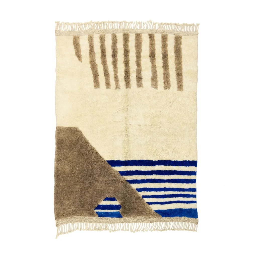 Artisanal rug with a geometric design, featuring beige, brown, and blue shapes and lines. Hand-knotted with fringed edges on the short sides for an authentic touch.