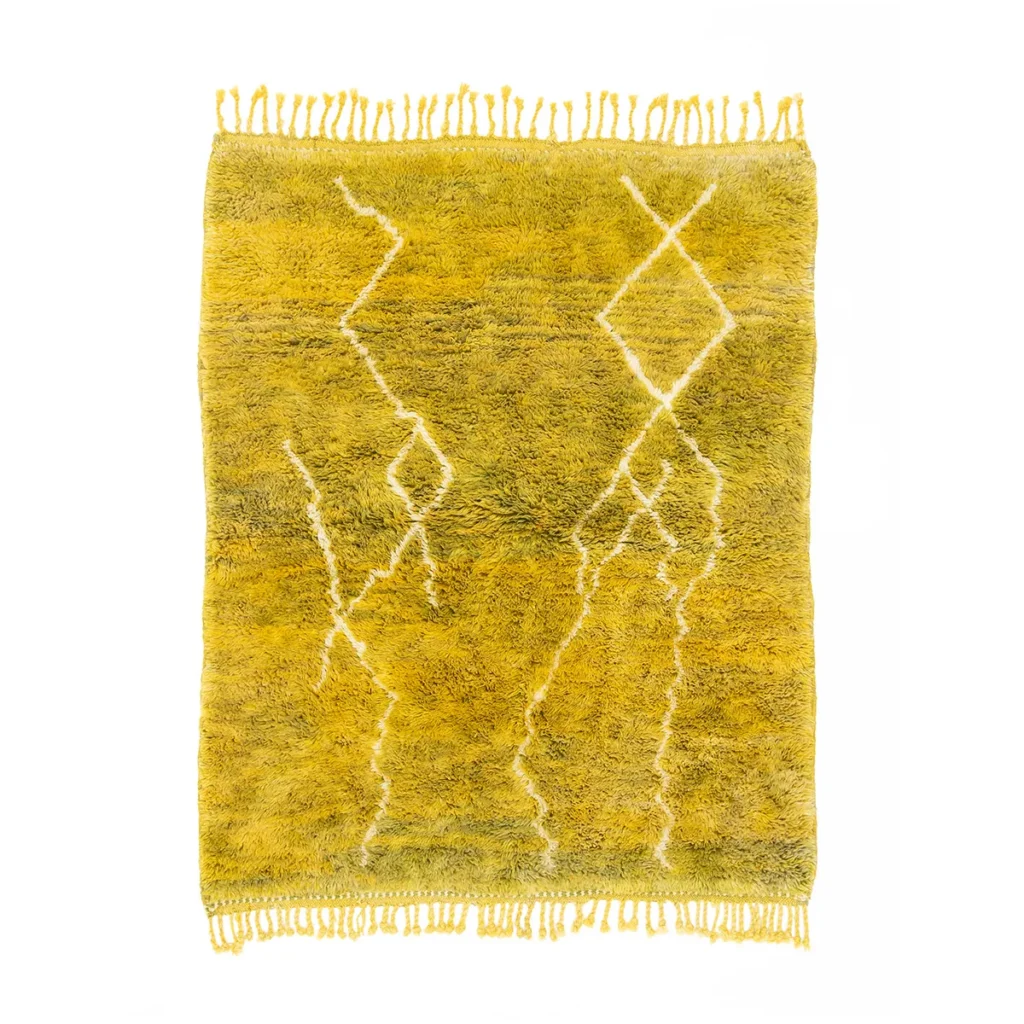 Luxurious yellow shaggy rug featuring white geometric patterns and fringed edges.