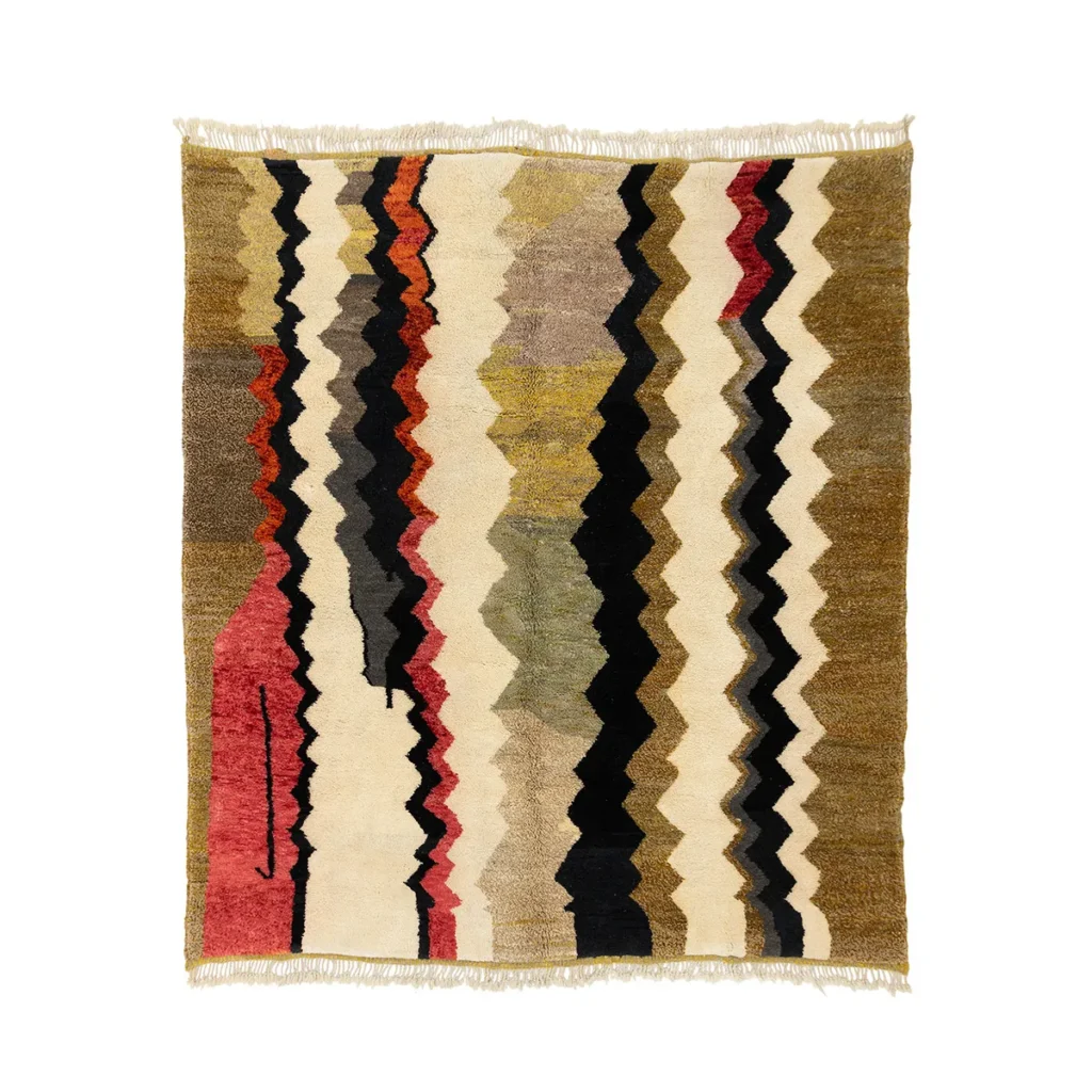 This artisanal rug is a multicolored woven masterpiece, showcasing a vibrant zigzag pattern in hues of red, black, olive, mustard, and beige. It features fringe on two edges and embodies the elegance of authentic Moroccan rugs.