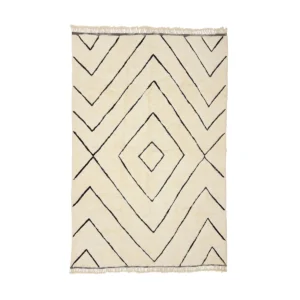 This luxurious beige rug, featuring a geometric black diamond pattern and fringed edges, is hand-knotted to perfection.