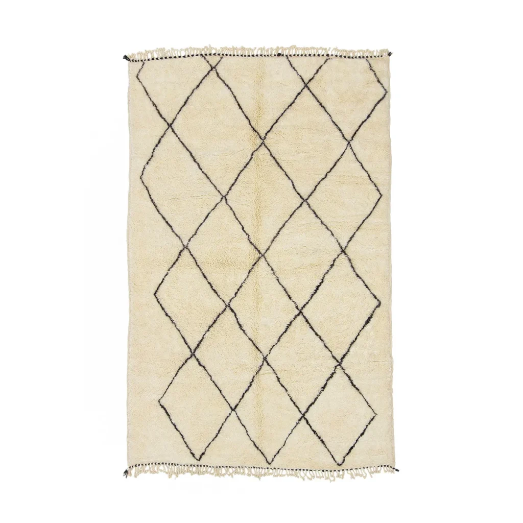 This authentic Moroccan rug features a cream-colored background adorned with a black diamond pattern. Hand-knotted with meticulous attention to detail, it showcases artisanal craftsmanship and elegant fringed edges.