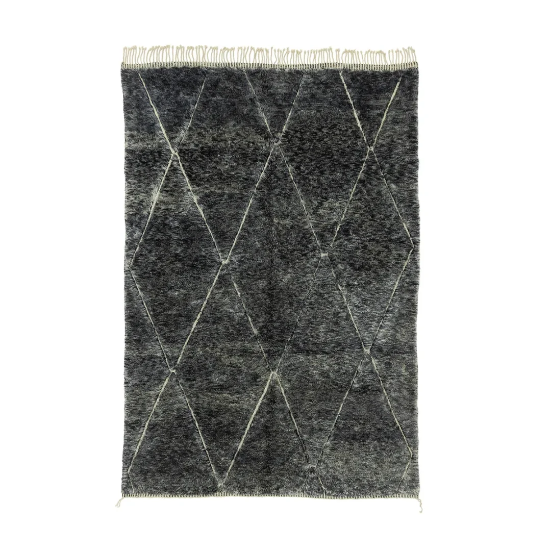 A dark gray textured artisanal rug with a diamond pattern, fringes on the short sides, and various shades creating a subtle gradient effect.