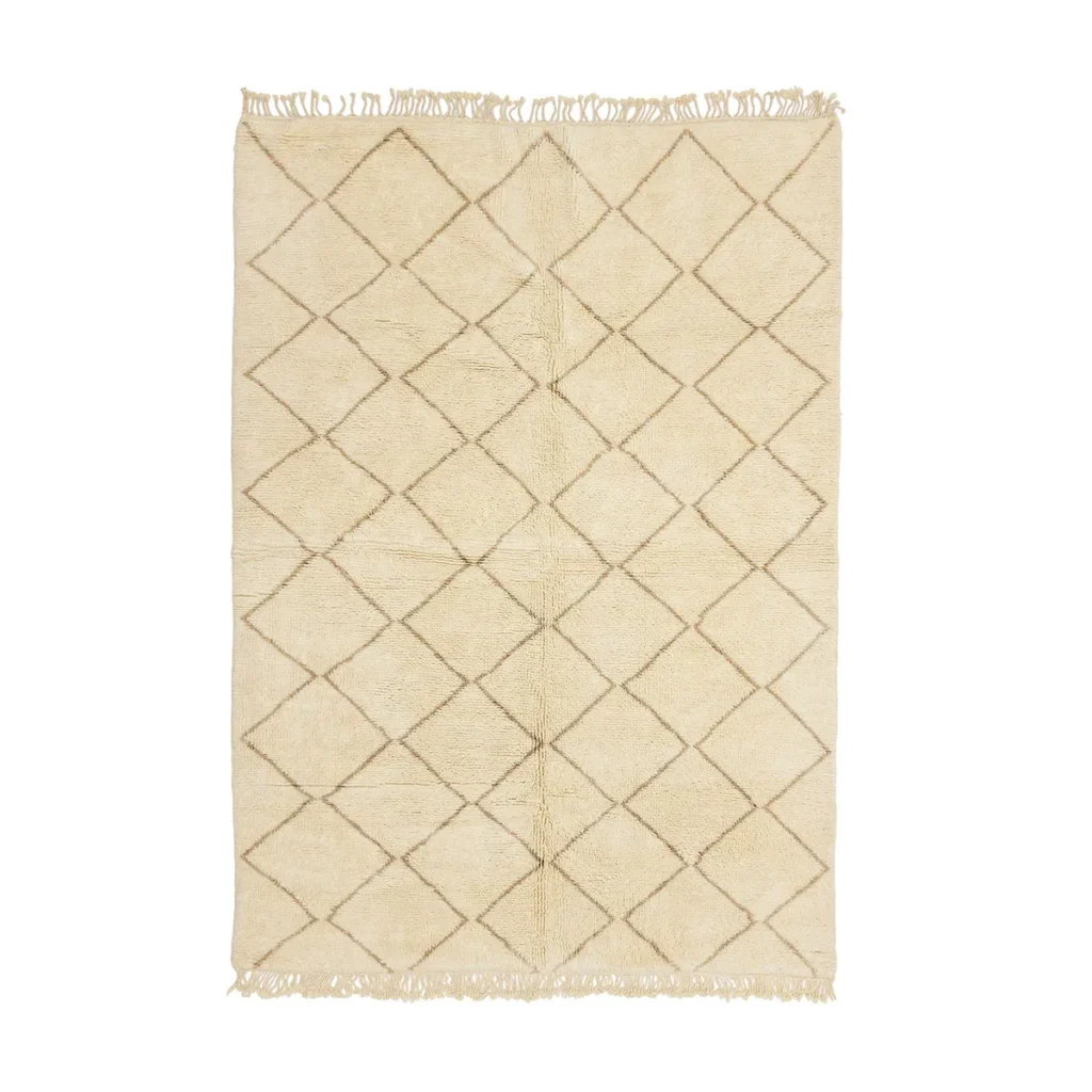 This luxurious Moroccan rug features an intricate diamond pattern and fringed edges, offering an elegant touch to any room. Hand-knotted in beige tones, this piece embodies craftsmanship and timeless style.