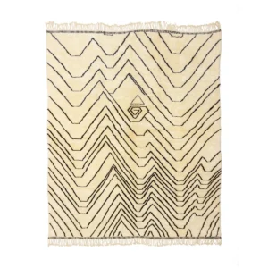 This luxurious, cream-colored rug features black zigzag patterns and a central geometric design. Hand-knotted with care, it exudes elegance, while fringe detailing enhances its artisanal charm. A perfect addition for those seeking exquisite handmade home decor.