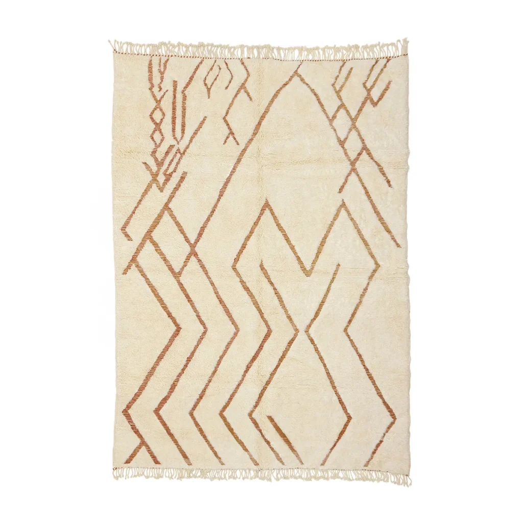 This hand-knotted rectangular beige rug boasts brown geometric and zigzag patterns, enhanced by fringed edges on the shorter sides. Its artisanal design lends an authentic Moroccan touch to any space.