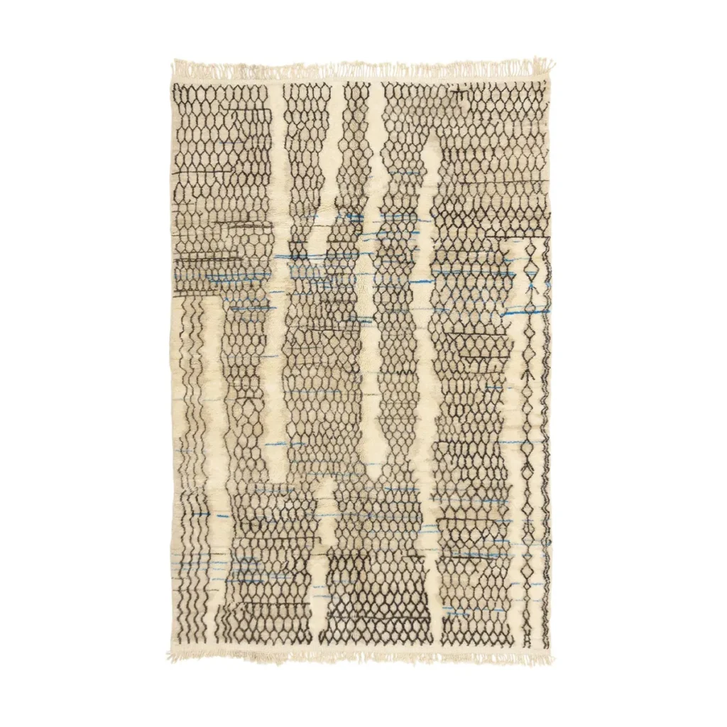 This artisanal rug features a rectangular beige and black pattern with fringe edges. Hand-knotted with irregular vertical lines and shapes, it delivers a textured, abstract look reminiscent of authentic Moroccan rugs.