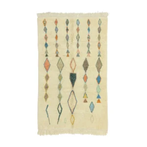This luxury hand-knotted rug features a cream-colored design adorned with vertical rows of diamond and triangle shapes in various colors, complete with fringe on the shorter edges.