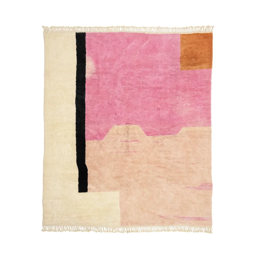 This handmade home decor piece is a luxurious rectangular rug featuring an abstract design in pink, beige, black, and orange sections. Its fringed edges on the shorter sides add a touch of elegance to any space.