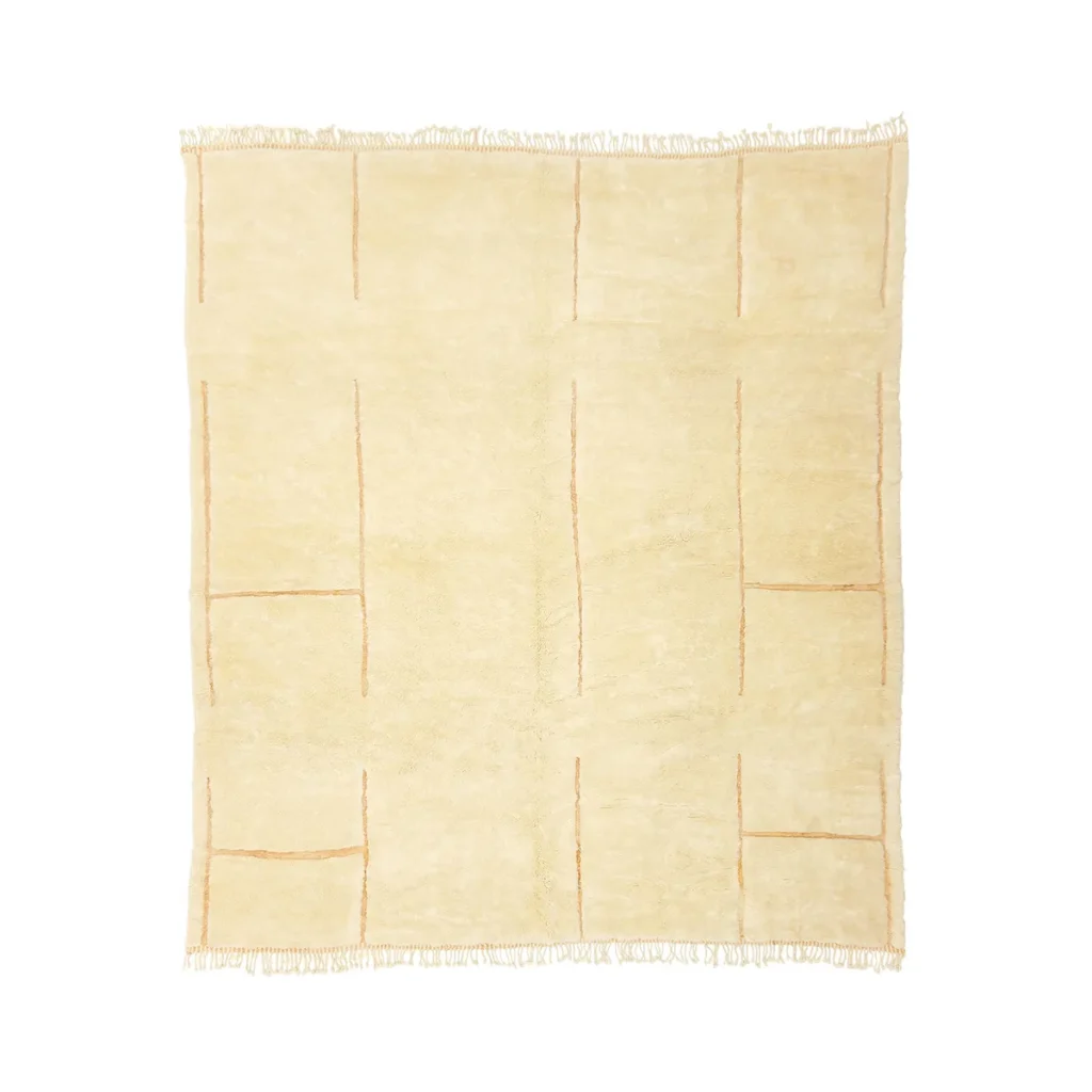 This hand-knotted beige square rug features a subtle grid pattern and fringed edges, adding a touch of luxury to any space.