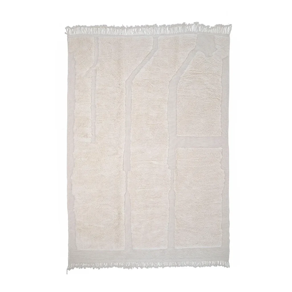 A rectangular, cream-colored rug with a textured geometric pattern and fringed edges, this hand-knotted piece is an artisanal gem.