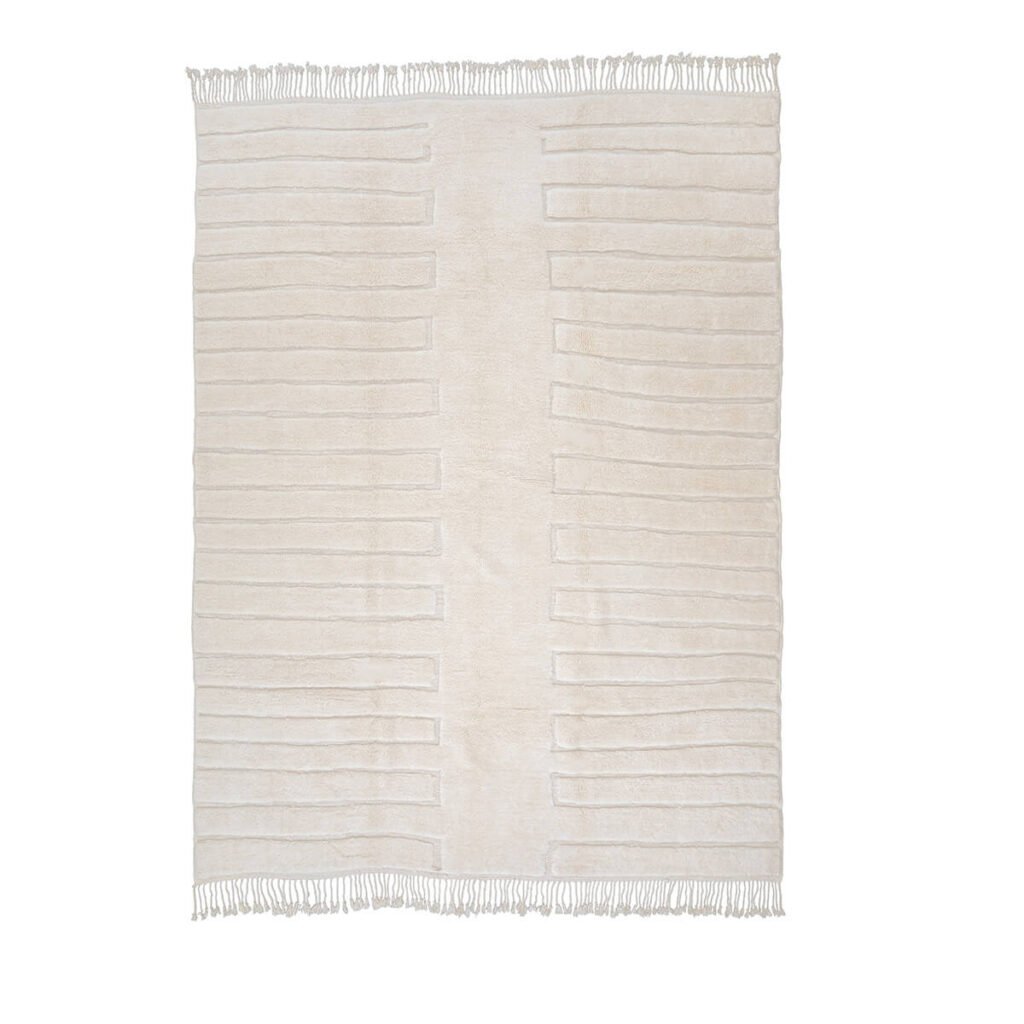 Discover the elegance of a cream-colored rectangular rug, artfully hand-knotted with subtle raised stripes and delicate fringe on the shorter edges. This piece epitomizes handmade home decor and effortlessly adds sophistication to any space with its luxurious touch.