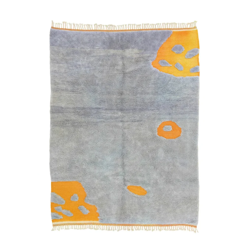 Hand-knotted gray rug with orange abstract patterns and fringed edges on top and bottom, crafted like authentic Moroccan rugs.