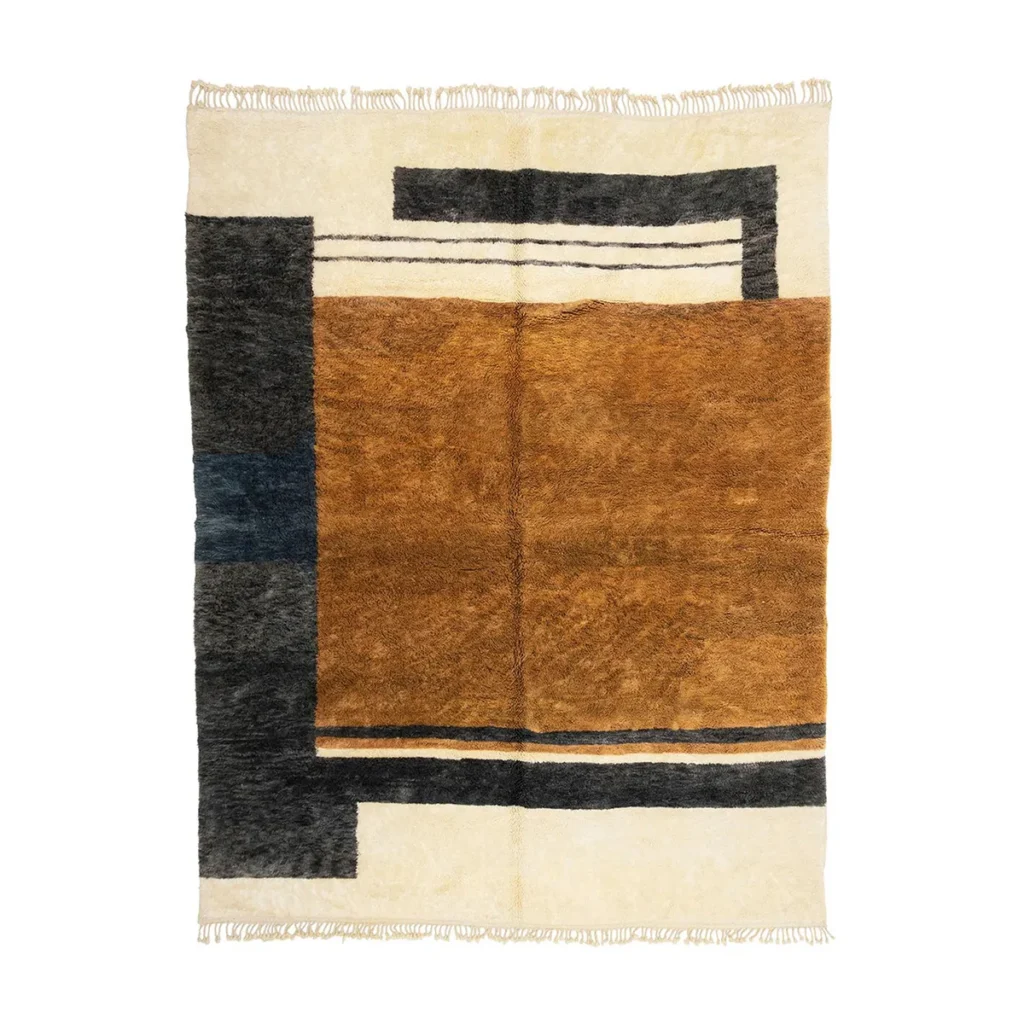 This hand-knotted rectangular wool rug showcases a modern geometric design with rich brown, beige, black, and dark blue blocks and lines. Luxury fringes grace the shorter edges, adding an extra touch of elegance.