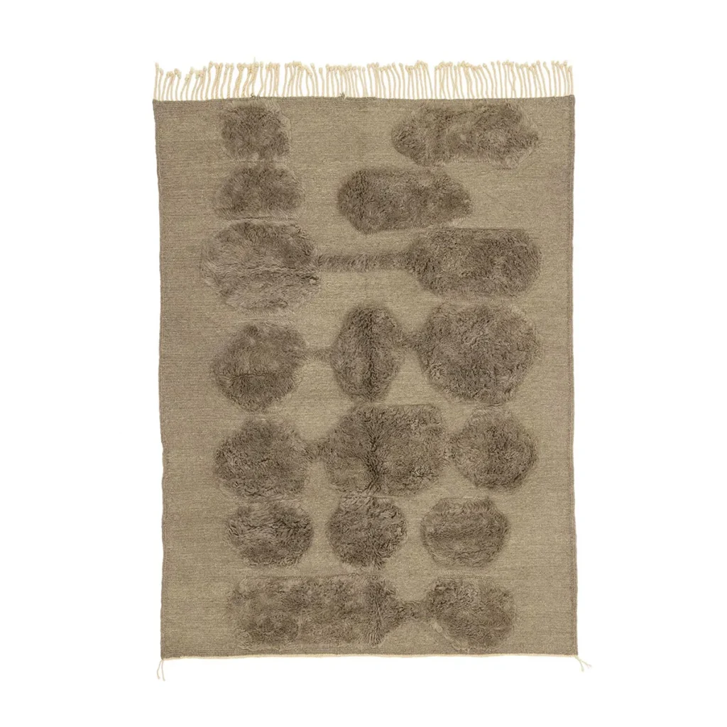 A hand-knotted beige rug with a fringe on one end, showcasing abstract, fluffy brown shapes in a symmetrical pattern. This artisanal rug adds an authentic Moroccan touch to any room.