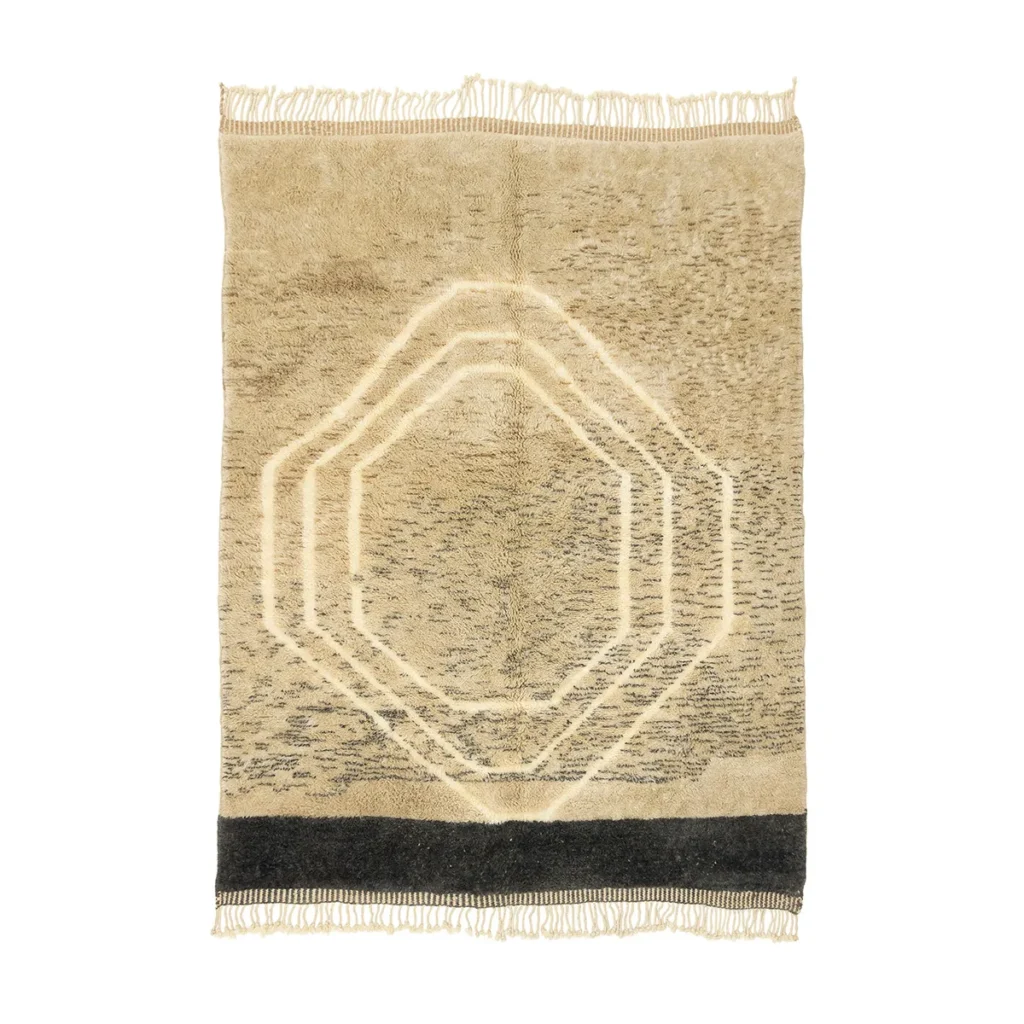 Experience the charm of this hand-knotted, beige woven rug with fringe edges. Its central hexagonal pattern is beautifully complemented by a dark border, embodying the artistry of authentic Moroccan rugs.