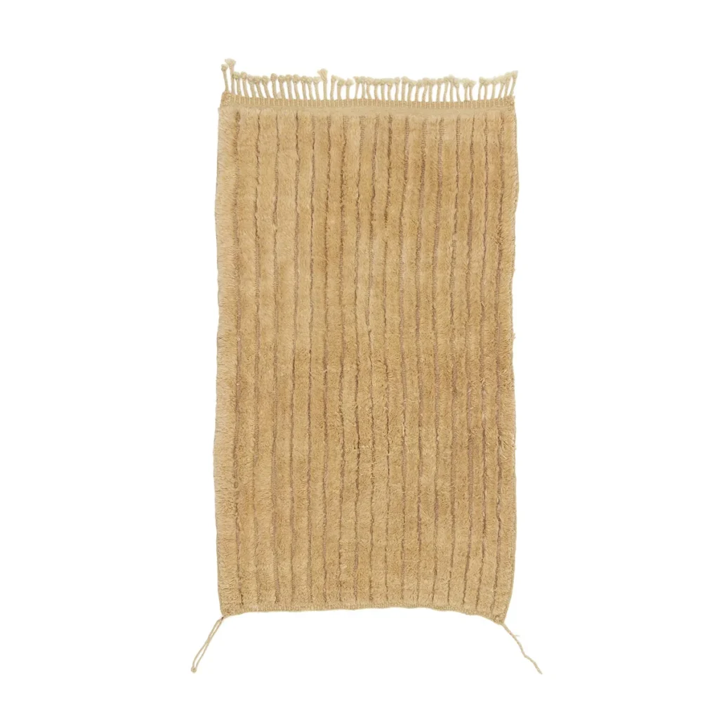 This hand-knotted rectangular beige rug features a striped texture with fringed edges on the top and bottom, exemplifying artisanal craftsmanship.