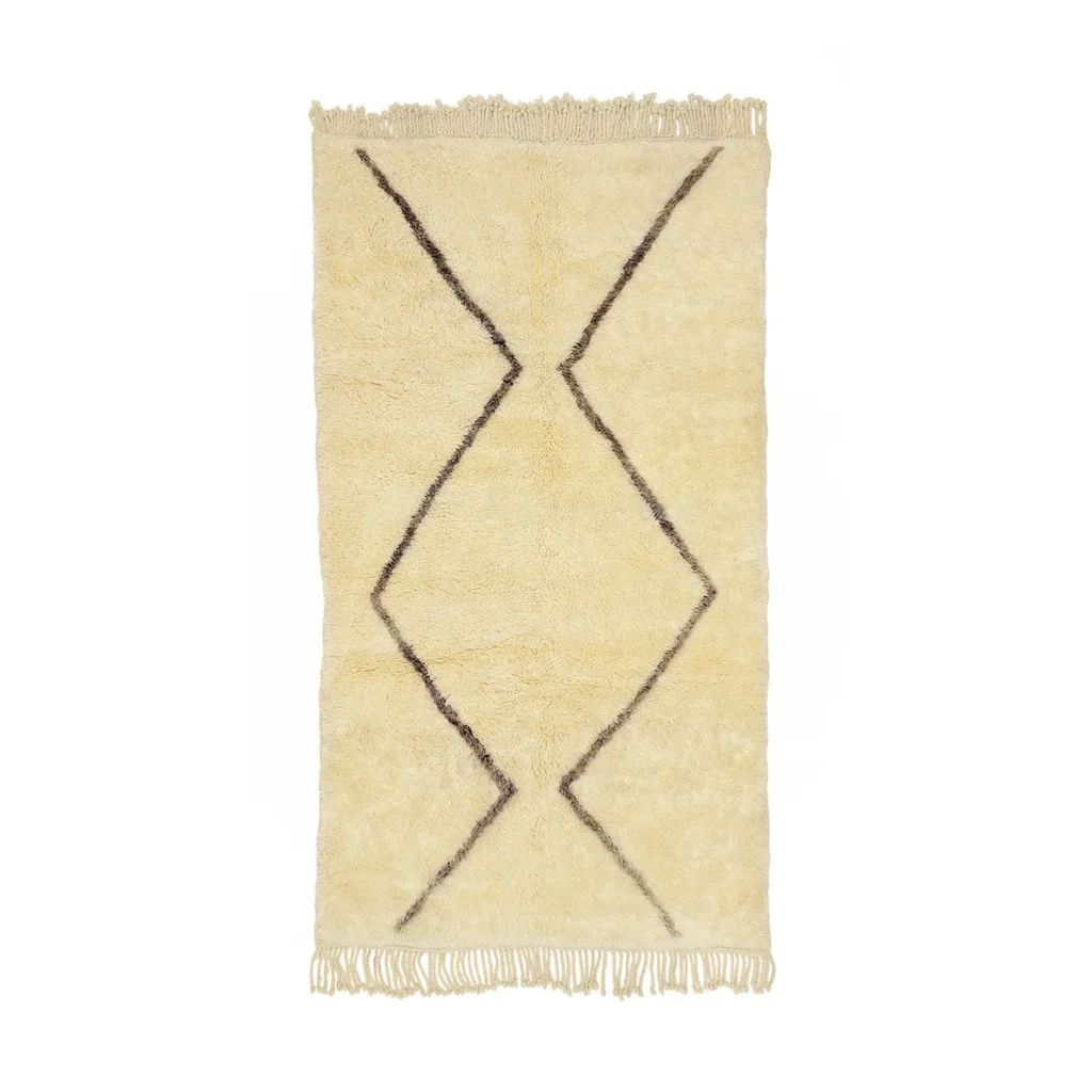 An artisanal rug in beige, featuring a simple geometric pattern and fringed edges. Hand-knotted with meticulous craftsmanship, this piece adds an understated elegance to any space.