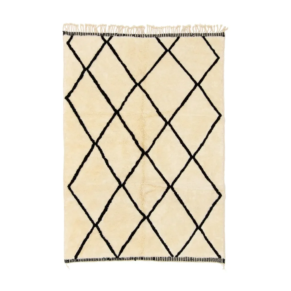 Experience the elegance of our beige hand-knotted rug, boasting a pattern of large black diamond shapes and fringed edges. Perfect for adding a touch of luxury to any room.