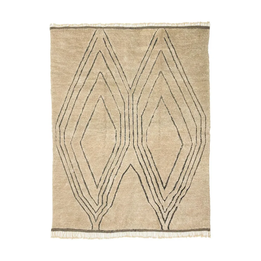 This artisanal rug is a beige rectangular piece with fringed edges, showcasing a symmetrical geometric pattern of overlapping diamond shapes in black lines. Hand-knotted for quality, it reflects the style of authentic Moroccan rugs.