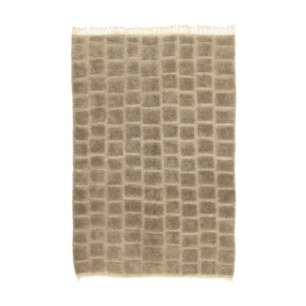 An artisanal beige rug featuring a checkered pattern and fringed edges, showcasing the craftsmanship of authentic Moroccan rugs.