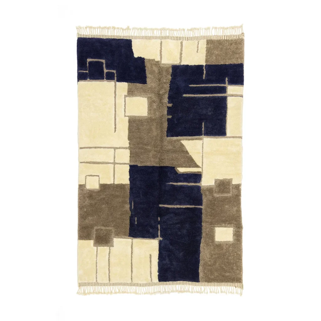 This artisanal rug showcases an abstract geometric pattern in beige, brown, and navy blue, complete with elegant fringed edges. Hand-knotted to perfection, its a stunning addition to any space.