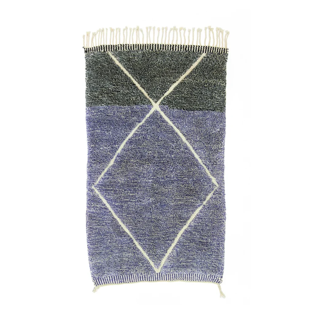 This hand-knotted rectangular rug boasts a blue and gray geometric design, featuring a large diamond shape outlined in white and adorned with fringe on the shorter sides. Its artisanal craftsmanship adds an authentic Moroccan touch to any space.