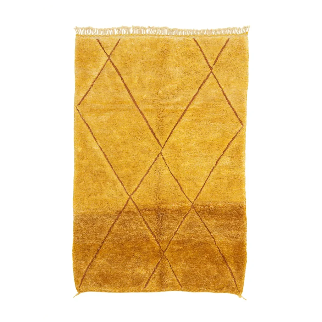 This luxury yellow rug boasts a geometric diamond pattern with elegant brown lines and is beautifully hand-knotted. The fringe detailing on one end adds a touch of sophistication, making it a perfect addition to any stylish interior.
