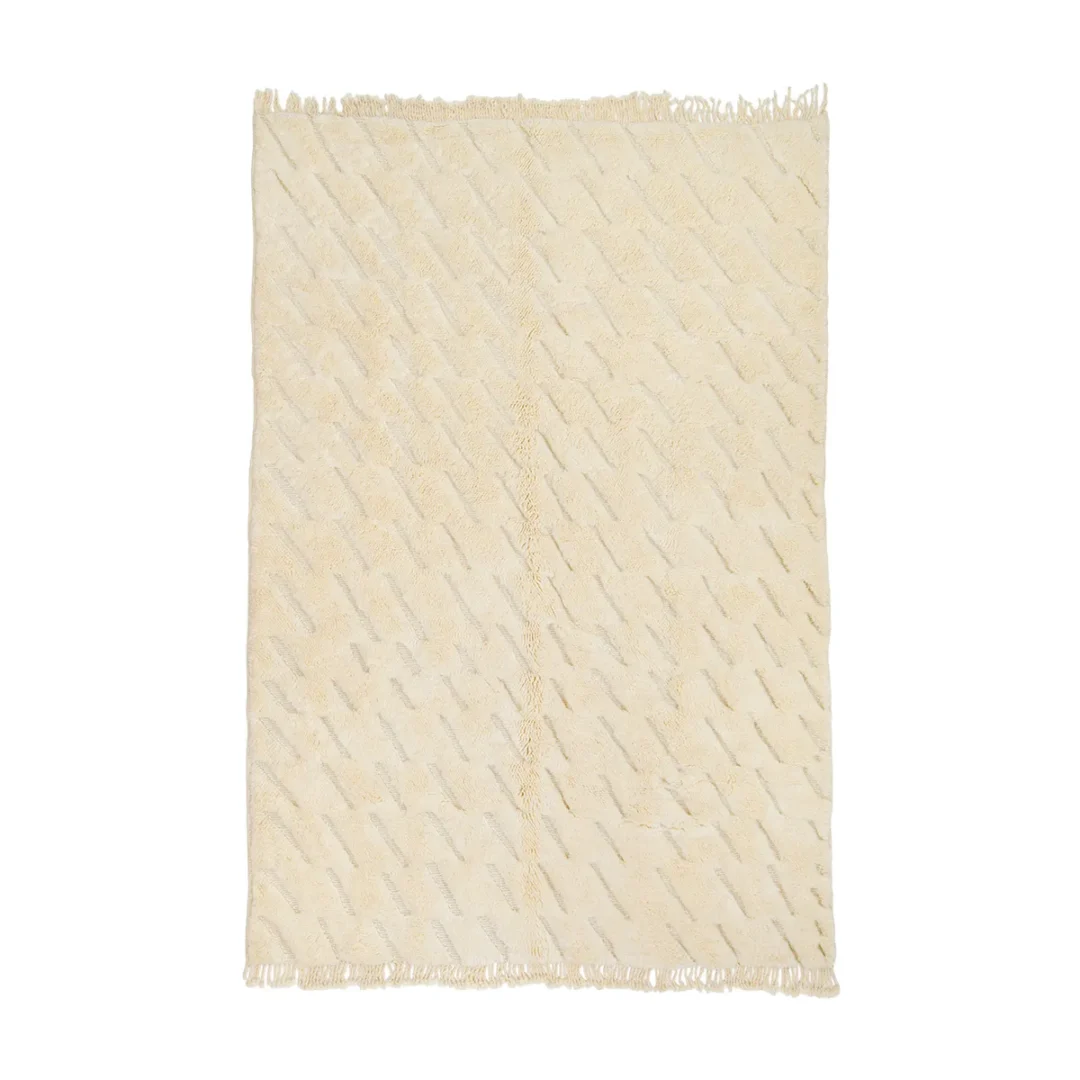 Beige rug with subtle diagonal lines and fringed edges.