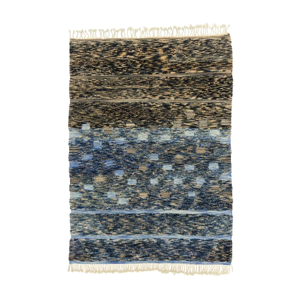 Hand-knotted rug with a gradient design featuring shades of blue, black, and beige, and short tassels on the edges.