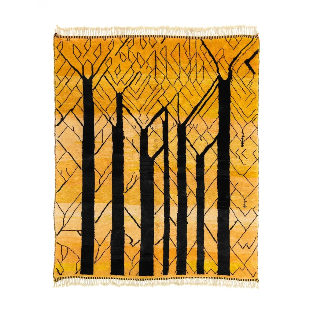 Square abstract rug with a design of vertical black tree trunk shapes on a yellow and orange background.