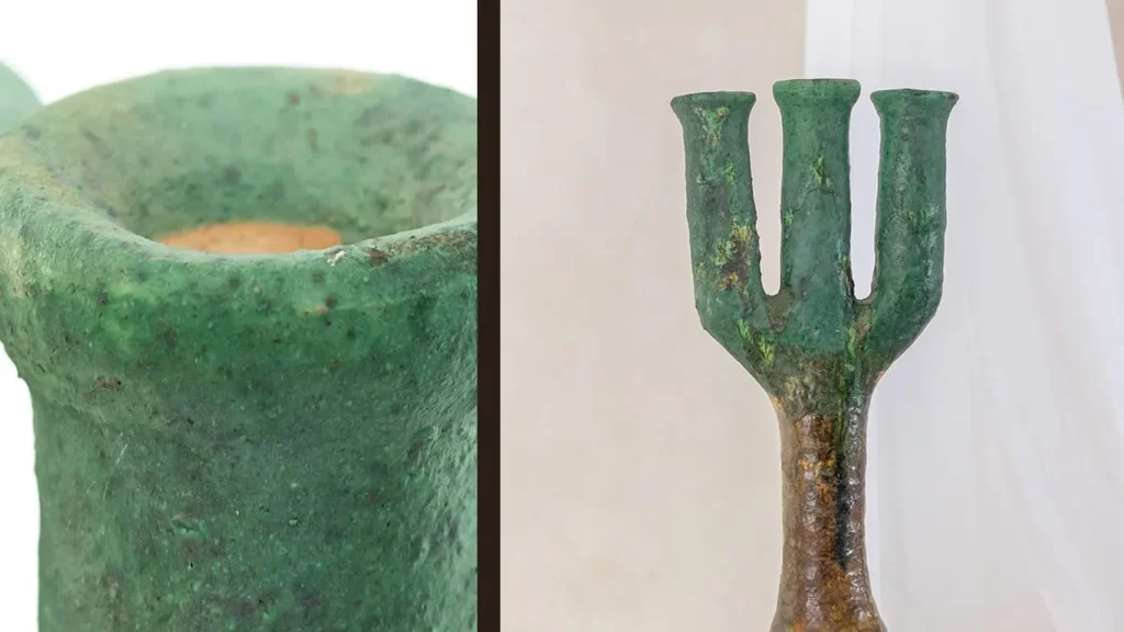 Close-up of a green ancient weapon resembling a trident with aged, textured surface, shown from two angles.