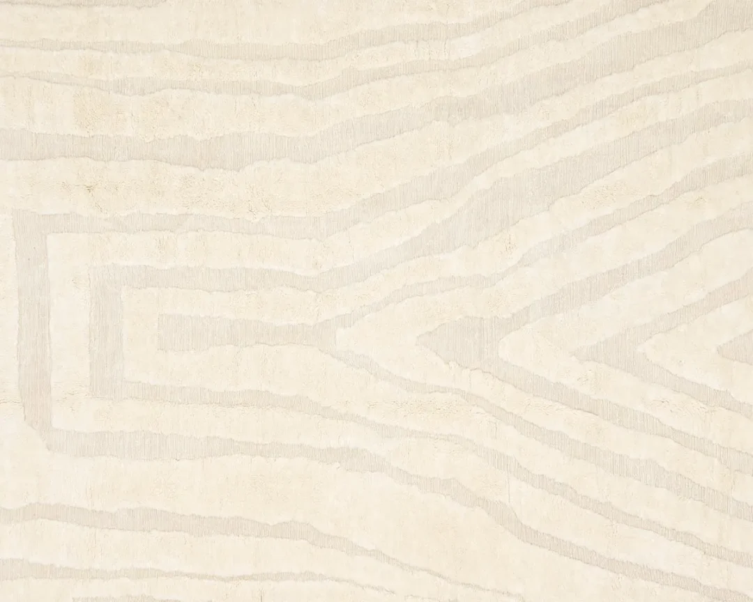 A beige and cream surface with an abstract, wavy, wood grain-like pattern.