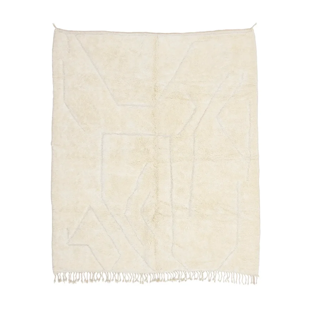 A rectangular cream-colored rug with subtle geometric patterns and fringe tassels along the bottom edge.