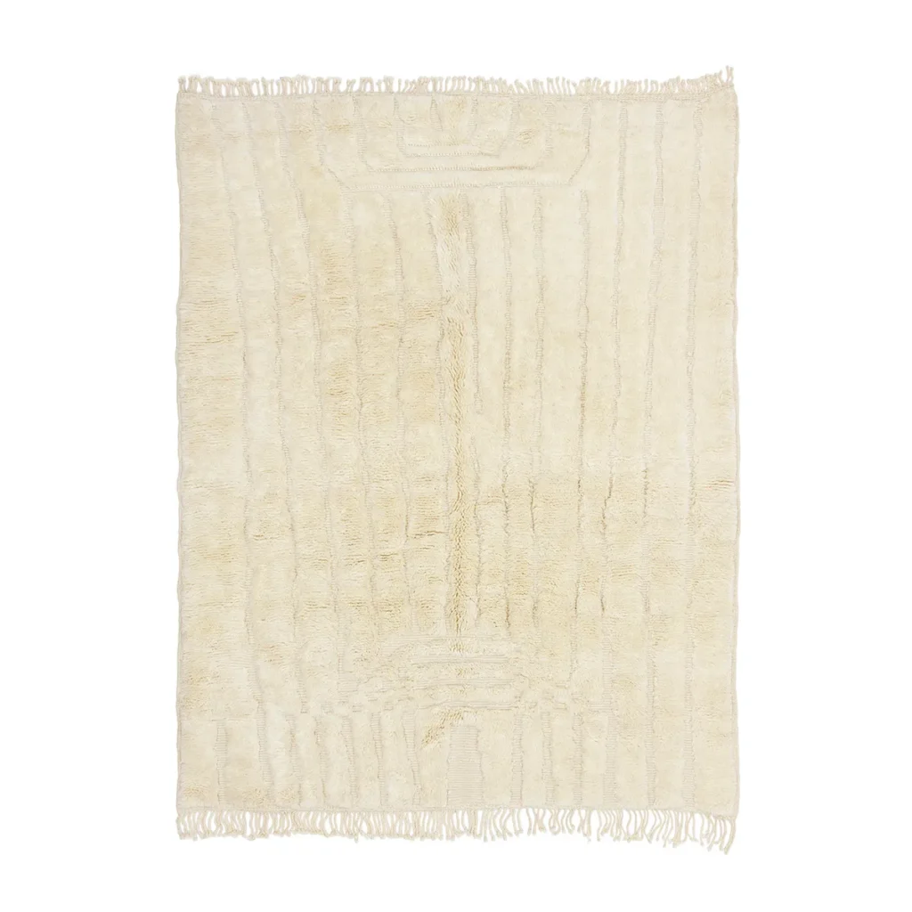A rectangular, cream-colored area rug with a subtle textured pattern and short fringe on the edges.