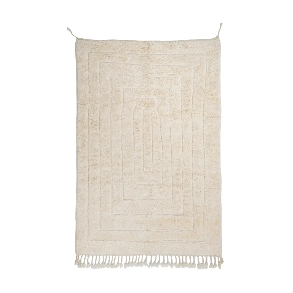 Rectangular beige rug with a geometric border pattern and short fringe tassels along the bottom edge, displayed against a white background.