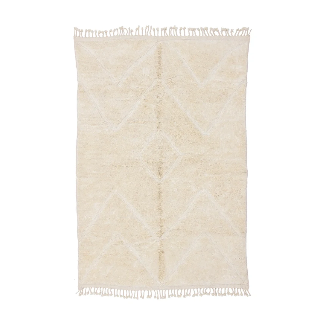 Rectangular cream-colored rug with subtle geometric patterns and fringe along the shorter edges, displayed on a white background.